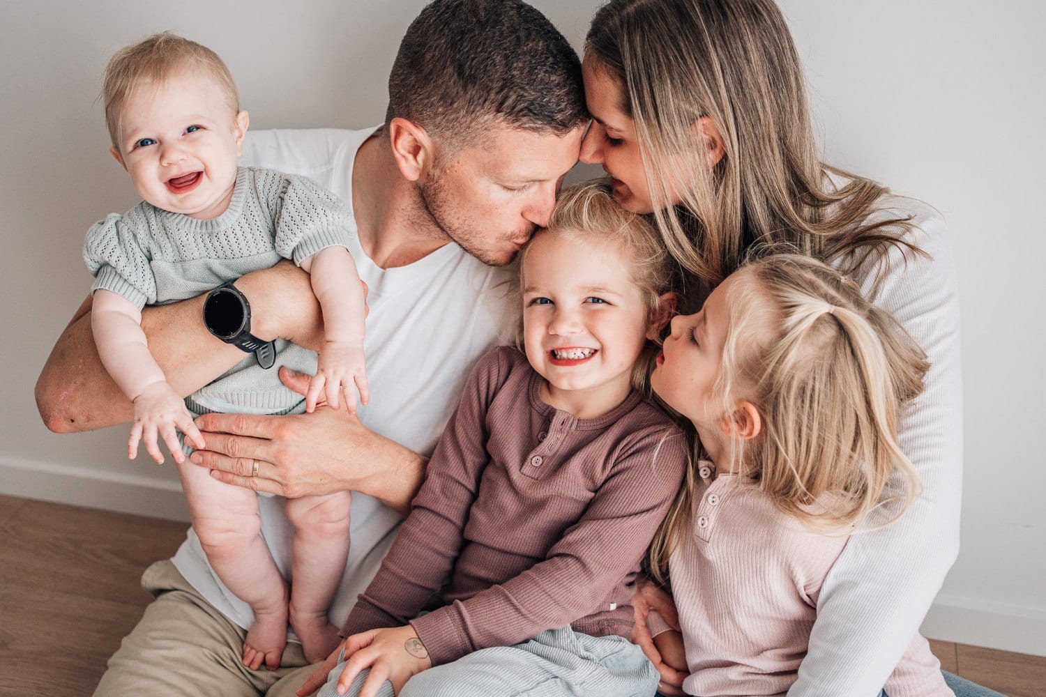 A family of five sharing a relaxed moment during a studio session
