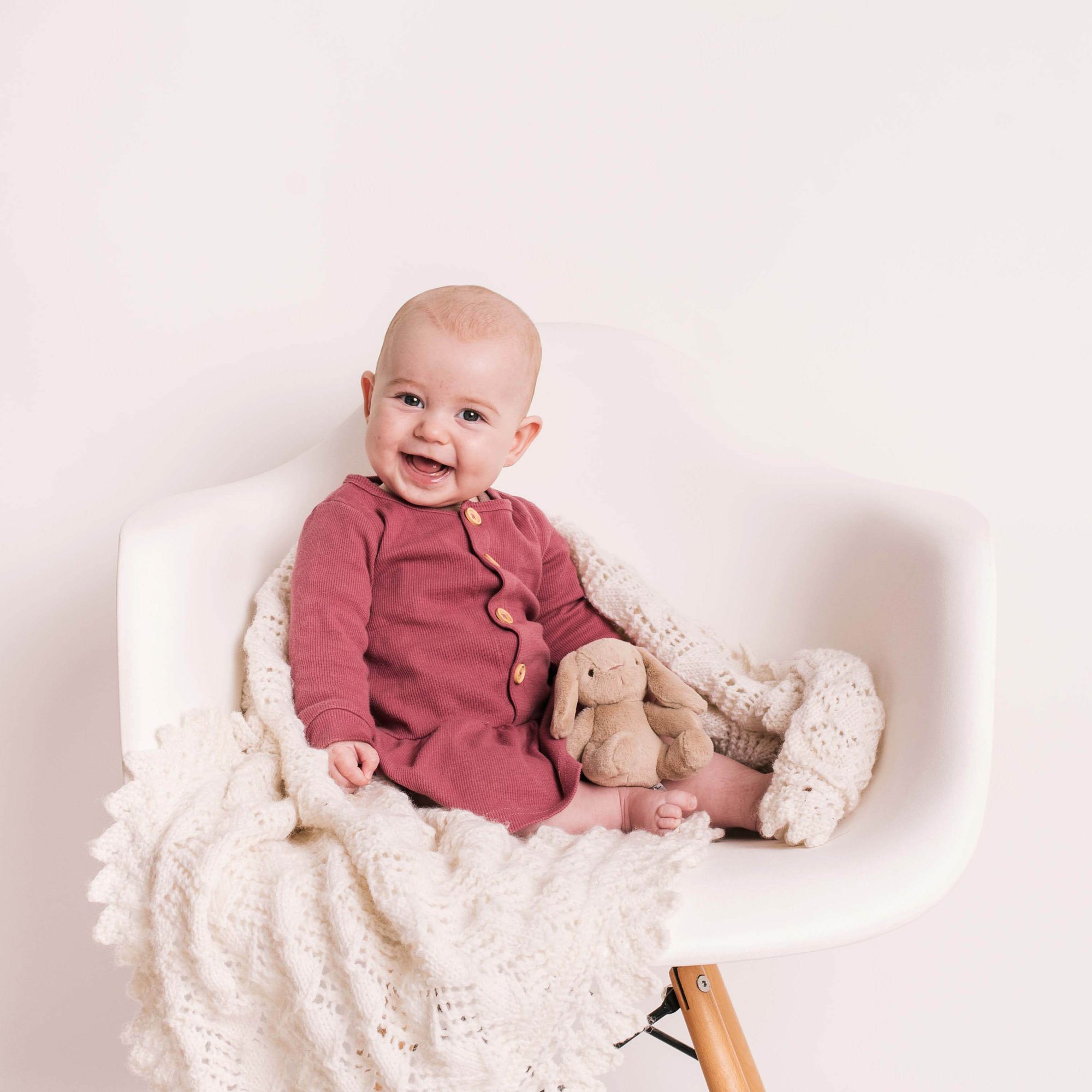 A child smiling during a studio portrait
