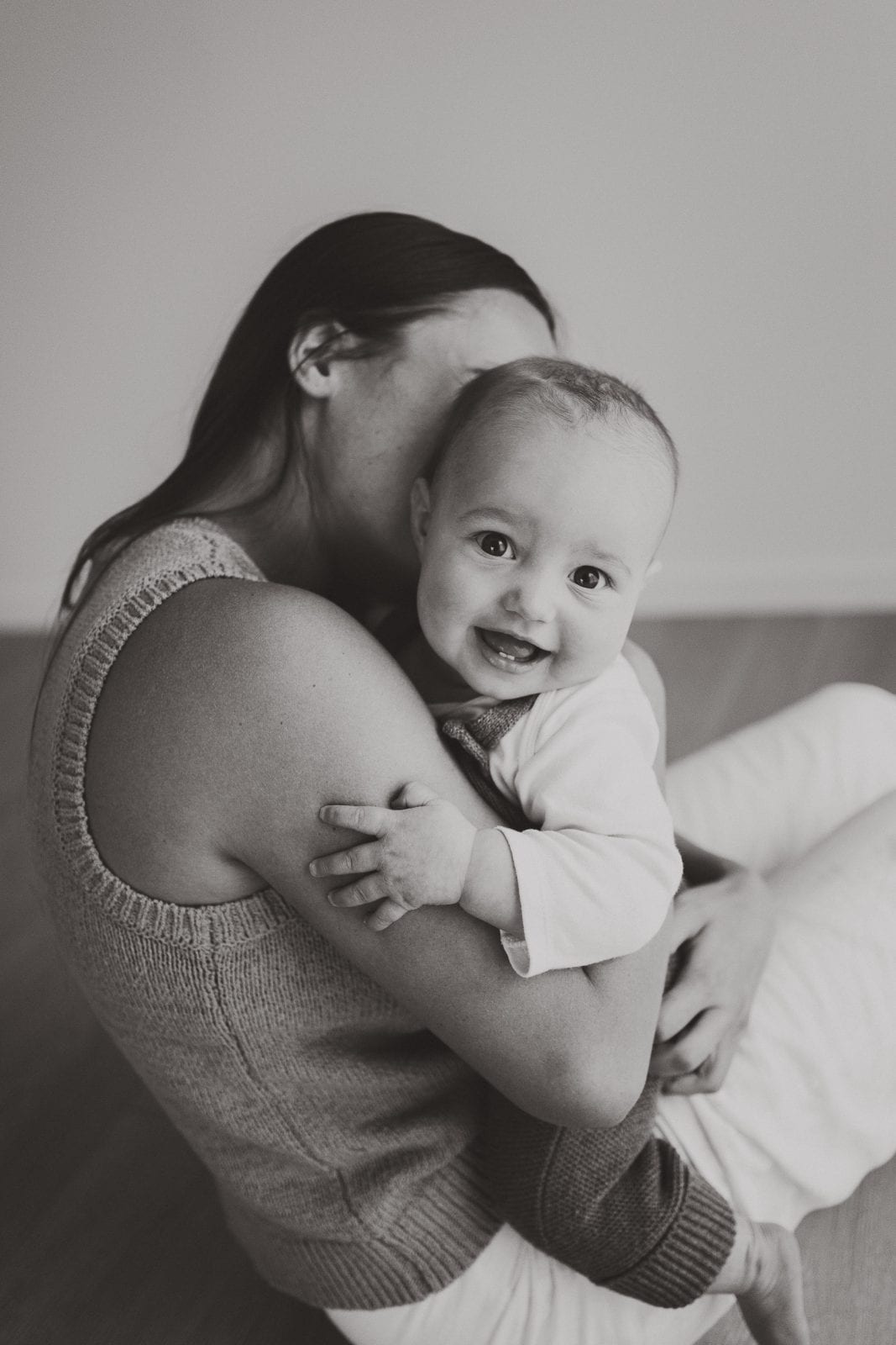 A tender black and white moment between mother and baby