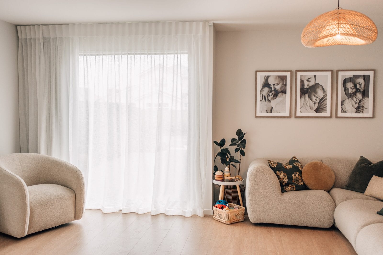 Sheer curtains filtering daylight across the boucle seating in the lounge of our Lincoln, Canterbury portrait studio.