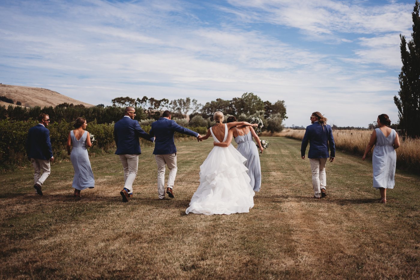 A bridal party walking together and laughing