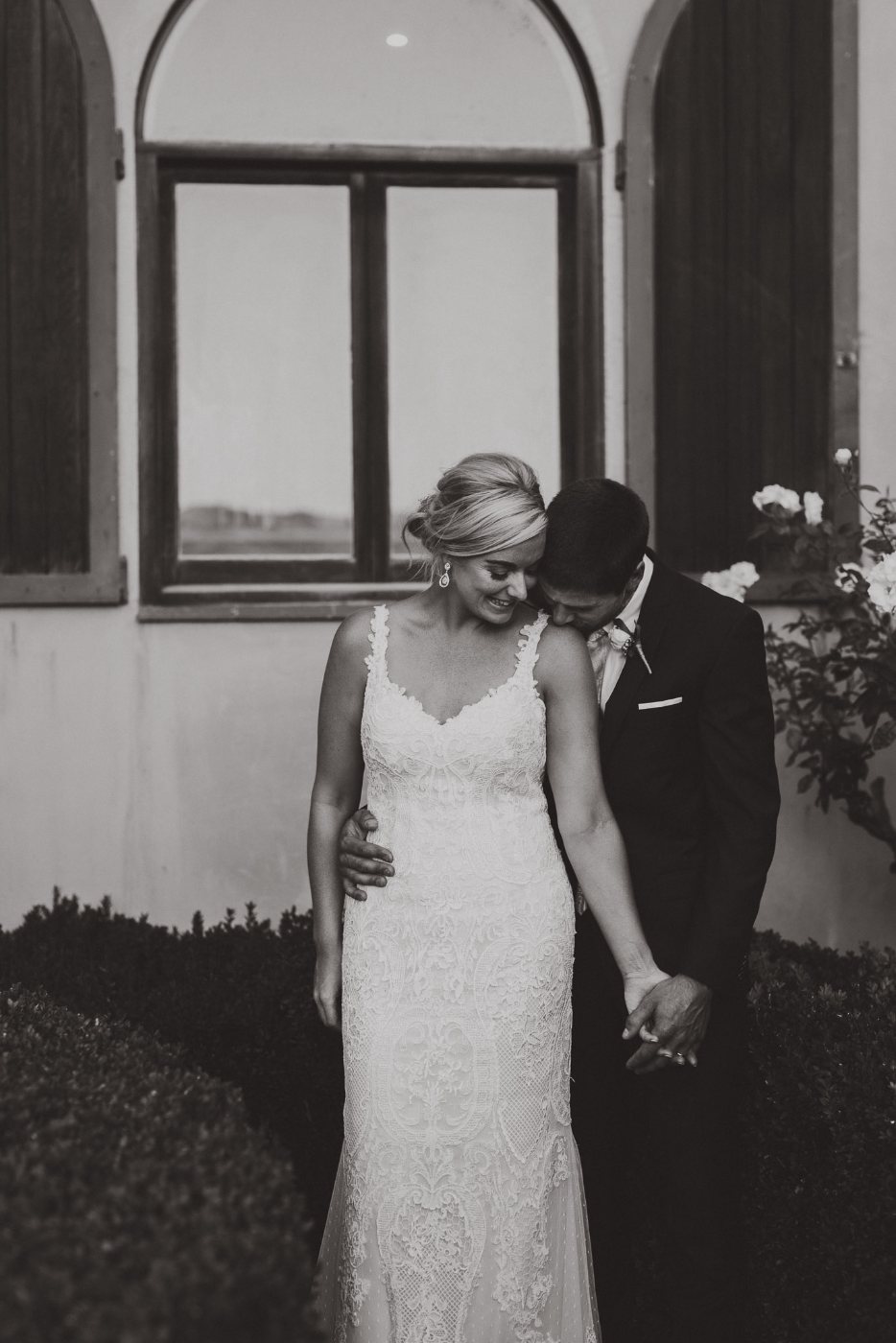 A black and white moment by an arched window
